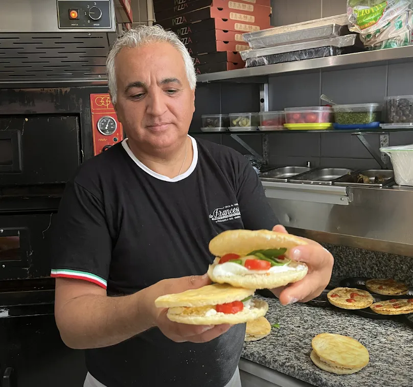 Francesco holding two filled focaccia sandwiches